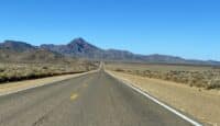 a road with mountains in the background