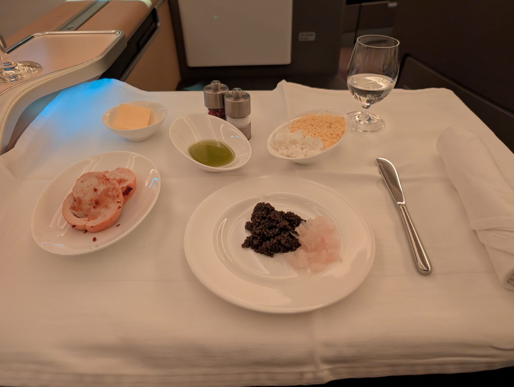 a table with plates of food and a glass of water