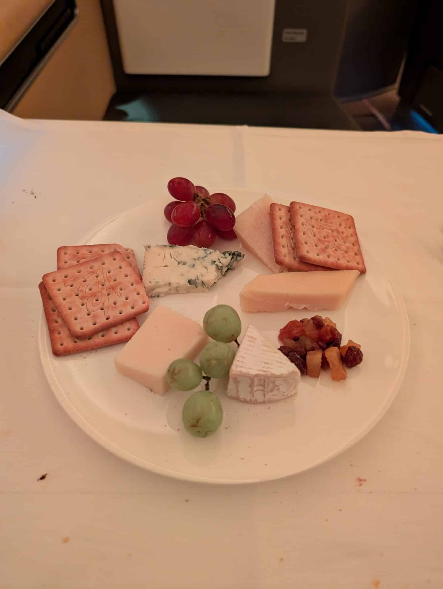 a plate of cheese crackers grapes and crackers