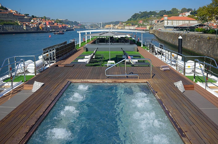 a boat with a jacuzzi on the water